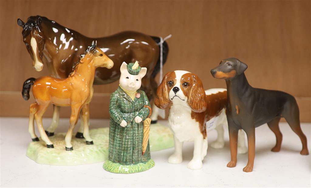 Four Beswick figures: The Lady Pig, King Charles Spaniel, a Doberman, and a horse and foal group, tallest 19cm